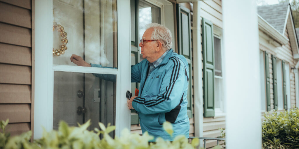 elderly man knocking on a door