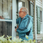 elderly man knocking on a door