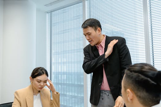 Diverse business team engaged in a serious discussion during a meeting in a modern office setting.